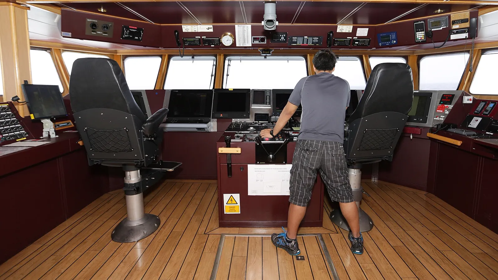 An officer of the watch at the bridge controls of a survey vessel